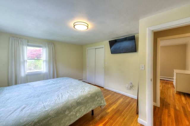 36 Winthrop St, West Boylston, MA 01583 - bedroom with a baseboard radiator, wood finished floors, baseboards, and a closet