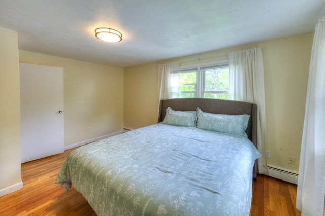 36 Winthrop St, West Boylston, MA 01583 - bedroom with baseboard heating, wood finished floors, and baseboards