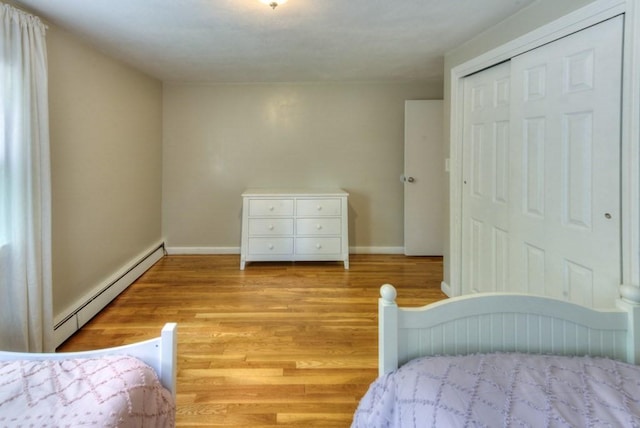 36 Winthrop St, West Boylston, MA 01583 - bedroom with a baseboard heating unit, baseboards, and light wood finished floors