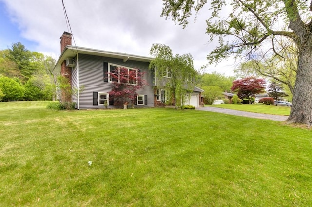 36 Winthrop St, West Boylston, MA 01583 - raised ranch featuring driveway, a chimney, a garage, and a front lawn