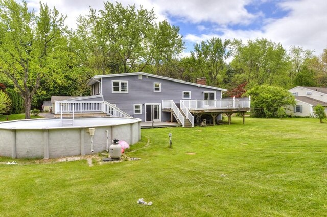 36 Winthrop St, West Boylston, MA 01583 - rear view of house with a deck, stairway, an outdoor pool, and a chimney