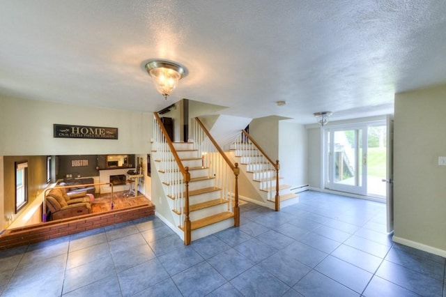 36 Winthrop St, West Boylston, MA 01583 - stairway with baseboards, tile patterned floors, a baseboard heating unit, and a textured ceiling