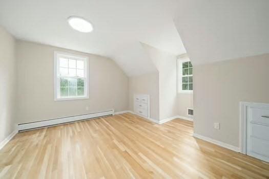 368 King St, Hanover, MA 02339 - additional living space featuring a baseboard radiator, wood finished floors, vaulted ceiling, and baseboards