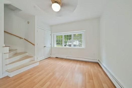 368 King St, Hanover, MA 02339 - empty room featuring baseboard heating, wood finished floors, and stairs