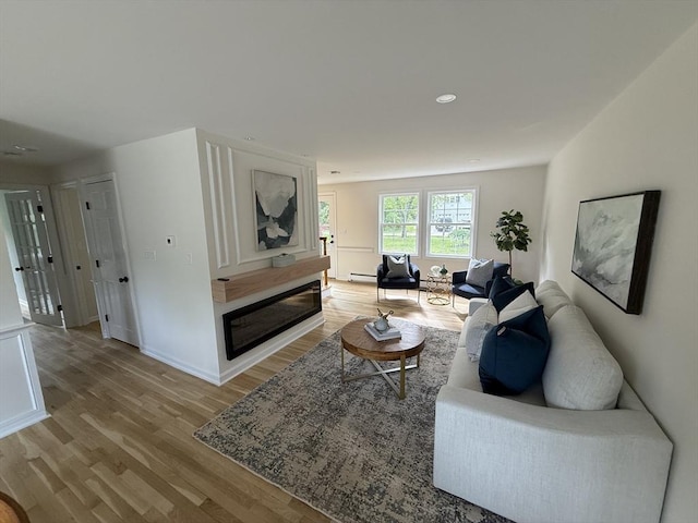 368 King St, Hanover, MA 02339 - living room with light wood finished floors, baseboards, recessed lighting, and a baseboard heating unit