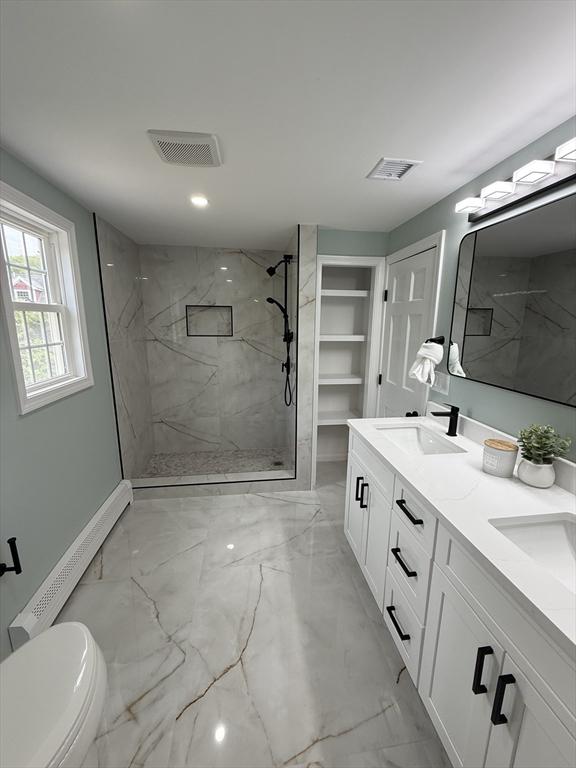 368 King St, Hanover, MA 02339 - full bathroom featuring marble finish flooring, a marble finish shower, double vanity, toilet, and a baseboard radiator