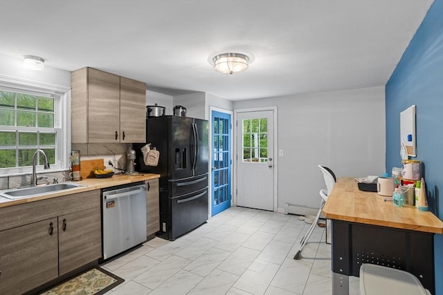 kitchen featuring stainless steel dishwasher, a sink, black refrigerator with ice dispenser, wooden counters, and light marble finish flooring