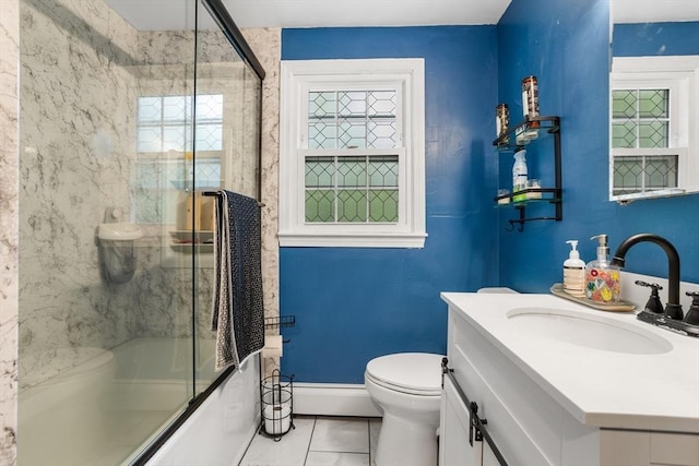 full bathroom with a baseboard heating unit, toilet, tile patterned floors, combined bath / shower with glass door, and vanity