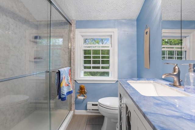 bathroom with toilet, healthy amount of natural light, a shower stall, baseboards, and a textured ceiling
