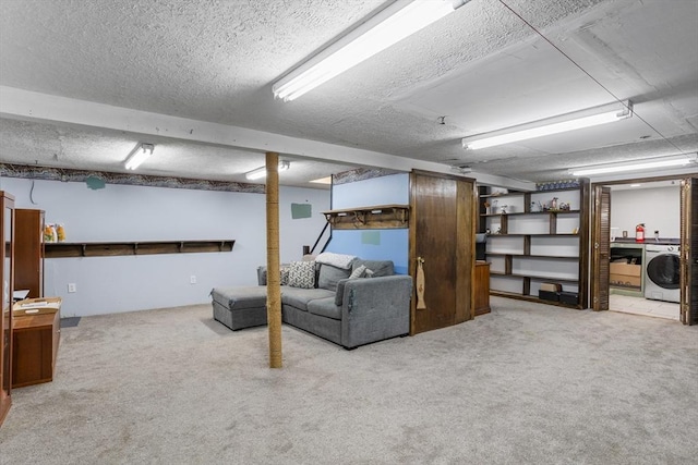 finished basement featuring washer / clothes dryer, carpet floors, and a textured ceiling