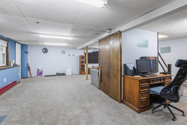 carpeted office with a textured ceiling