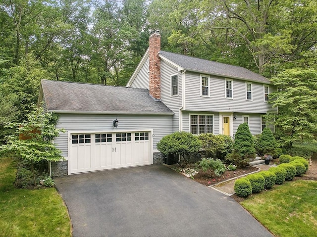 5 Coburn Rd, Hopkinton, MA 01748 - colonial inspired home with a chimney, driveway, a garage, and roof with shingles