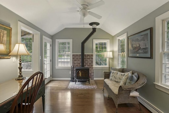 5 Coburn Rd, Hopkinton, MA 01748 - living area featuring a baseboard heating unit, a wood stove, wood finished floors, vaulted ceiling, and ceiling fan