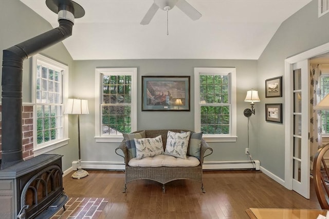 5 Coburn Rd, Hopkinton, MA 01748 - living area featuring a wood stove, a baseboard radiator, vaulted ceiling, hardwood / wood-style flooring, and baseboards