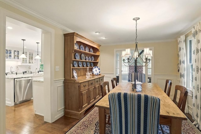 5 Coburn Rd, Hopkinton, MA 01748 - dining room with a decorative wall, wood finished floors, a chandelier, a wainscoted wall, and crown molding
