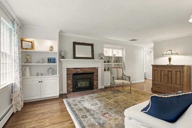 5 Coburn Rd, Hopkinton, MA 01748 - living area featuring baseboard heating, ornamental molding, a fireplace, wood finished floors, and built in shelves