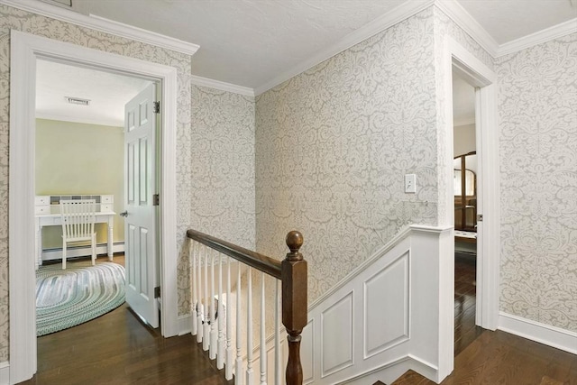 5 Coburn Rd, Hopkinton, MA 01748 - corridor featuring baseboard heating, dark wood finished floors, ornamental molding, wallpapered walls, and an upstairs landing