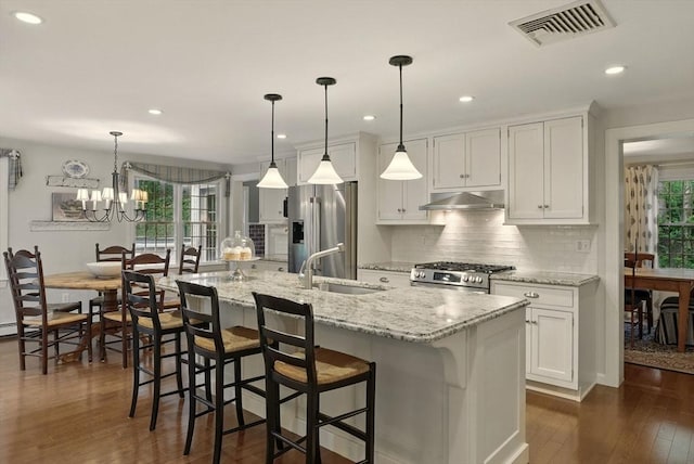 5 Coburn Rd, Hopkinton, MA 01748 - kitchen with stainless steel appliances, under cabinet range hood, a sink, tasteful backsplash, and dark wood-style floors