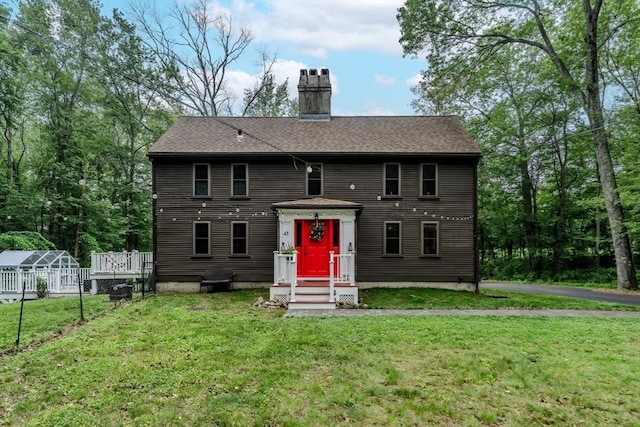 43 Mill Rd, North Andover, MA 01845 - view of front facade with a front lawn, a chimney, roof with shingles, and an exterior structure