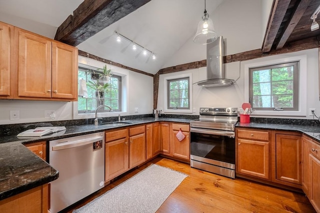 43 Mill Rd, North Andover, MA 01845 - kitchen featuring stainless steel appliances, wall chimney range hood, light wood-style floors, dark stone counters, and decorative light fixtures