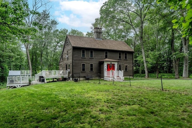 43 Mill Rd, North Andover, MA 01845 - back of property featuring a chimney, a lawn, a wooden deck, and a shingled roof