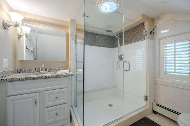 43 Mill Rd, North Andover, MA 01845 - full bath featuring a baseboard heating unit, a stall shower, vanity, and tile patterned floors