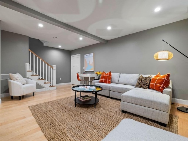 living room with beam ceiling and light hardwood / wood-style floors