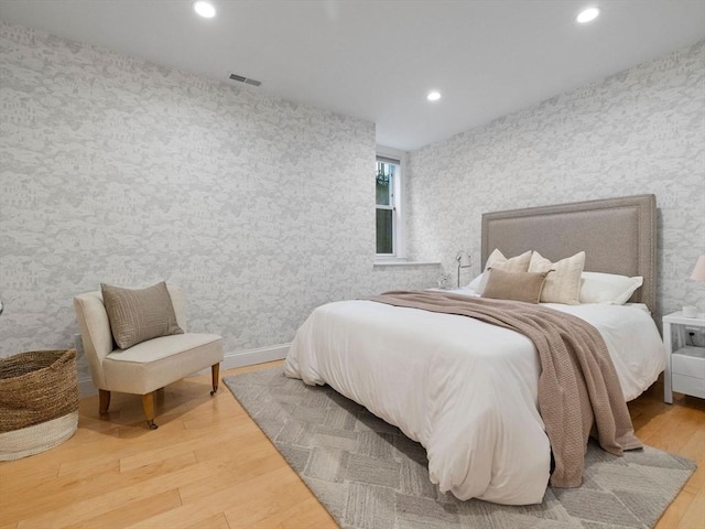 bedroom with hardwood / wood-style flooring