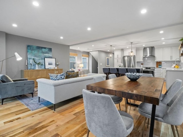 dining room with sink and light hardwood / wood-style flooring