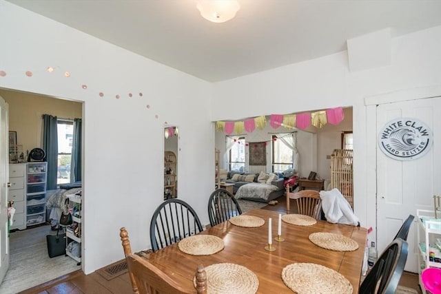 dining space featuring a healthy amount of sunlight and wood finished floors