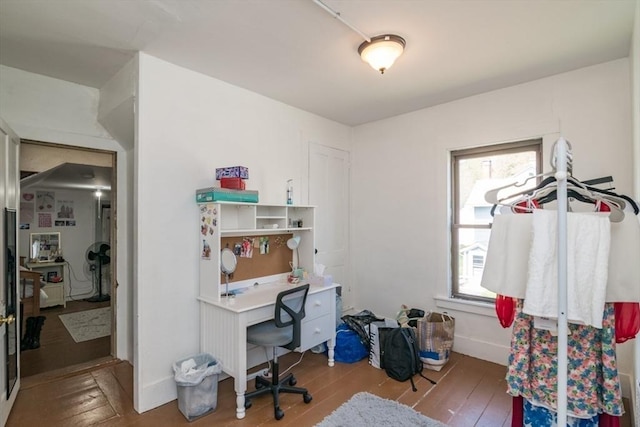 office area with baseboards, a wealth of natural light, and wood-type flooring