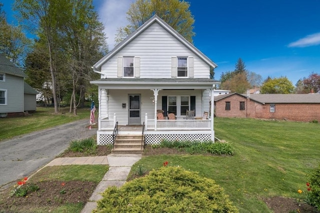 view of front of house with a porch and a front yard