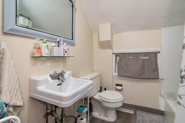 full bathroom featuring toilet, a sink, curtained shower, a bath, and wood finished floors