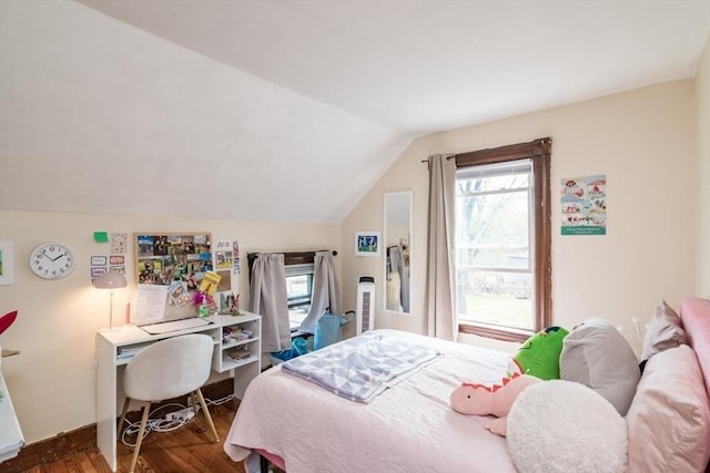 bedroom with vaulted ceiling, baseboards, and wood finished floors