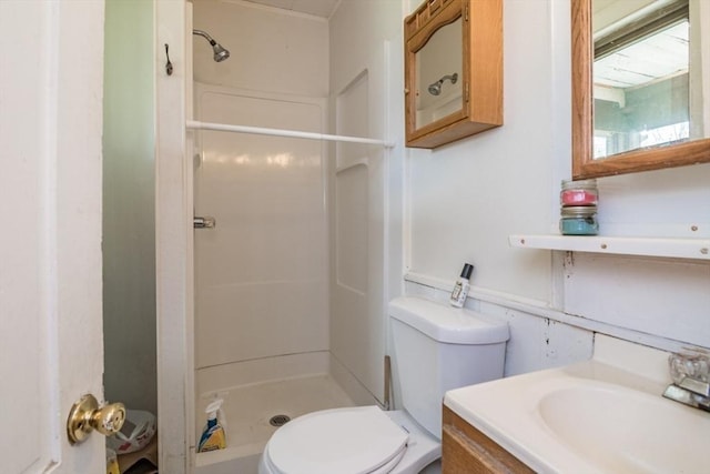 full bath with a shower stall, vanity, and toilet