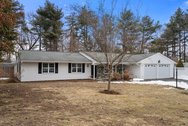 ranch-style house with a garage and fence