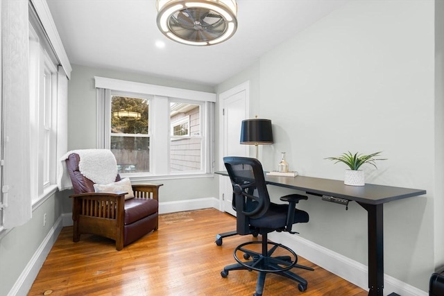 office area with baseboards and wood finished floors