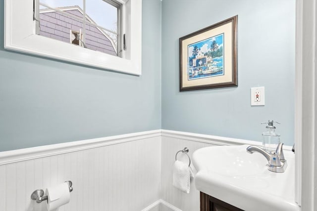 bathroom with vanity and wainscoting