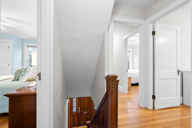 hallway featuring light wood-style floors and an upstairs landing