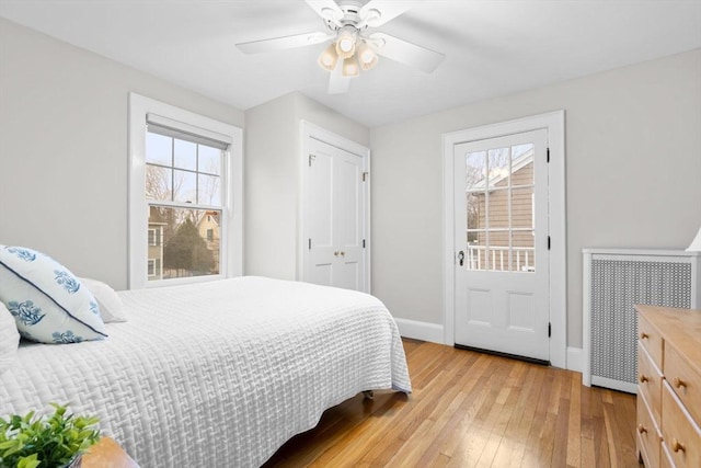 bedroom featuring ceiling fan, light wood-type flooring, and baseboards