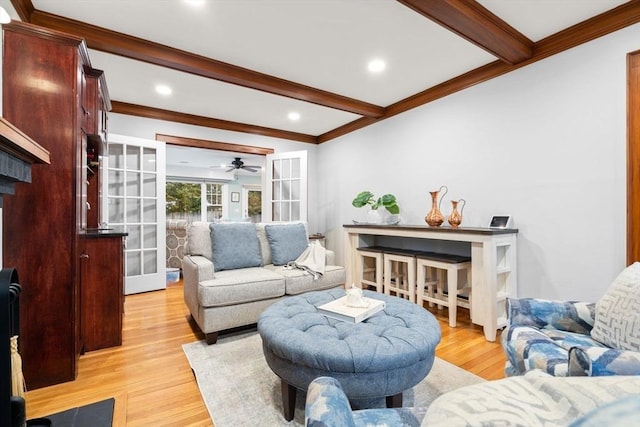 living area with light wood-style flooring, recessed lighting, ornamental molding, french doors, and beamed ceiling