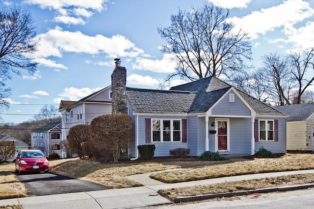 view of front of house with aphalt driveway and a chimney