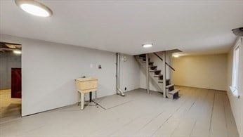 basement with hardwood / wood-style flooring