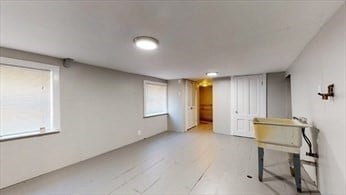 basement with light hardwood / wood-style floors