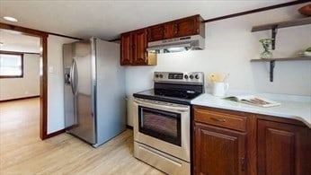 kitchen featuring stainless steel appliances and light hardwood / wood-style floors