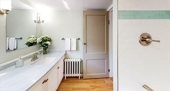 bathroom featuring wood-type flooring, vanity, and radiator heating unit