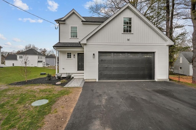 view of front facade with a front yard and a garage