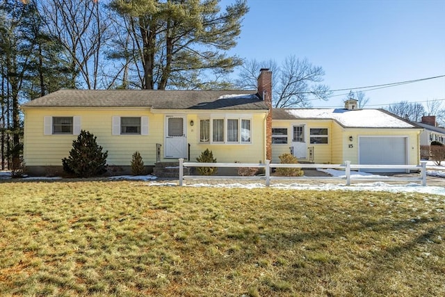 ranch-style home featuring a garage and a front lawn