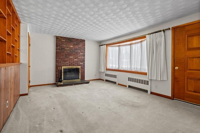 unfurnished living room featuring radiator heating unit, a fireplace, light carpet, and a textured ceiling