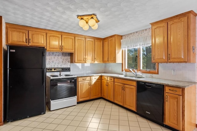 kitchen with tasteful backsplash, sink, black appliances, and light tile patterned flooring